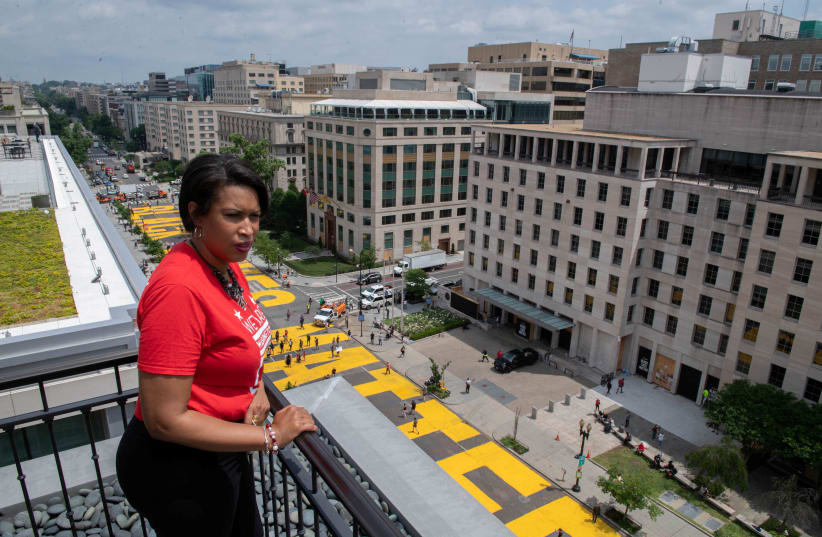 Mayor Muriel Bowser looks out over a Black Lives Matter sign that was painted on a street, during nationwide protests against the death in Minneapolis police custody of George Floyd, in Washington, D.C., U.S. June 5, 2020 (photo credit: KHALID NAJI-ALLAH EXECUTIVE OFFICE OF THE MAYOR/HANDOUT VIA REUTERS)