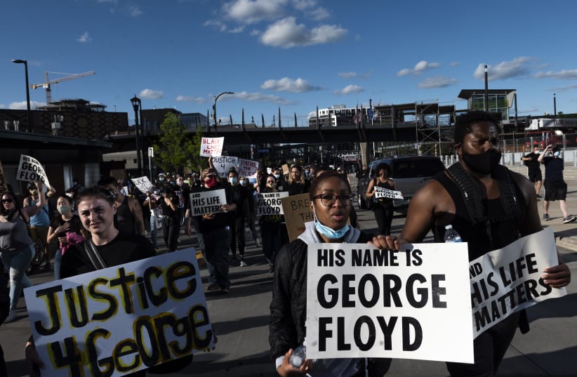 Protesters in Minneapolis demonstrate against the death in police custody of George Floyd, May 29, 2020 (photo credit: STEPHEN MATUREN/GETTY IMAGES/JTA)