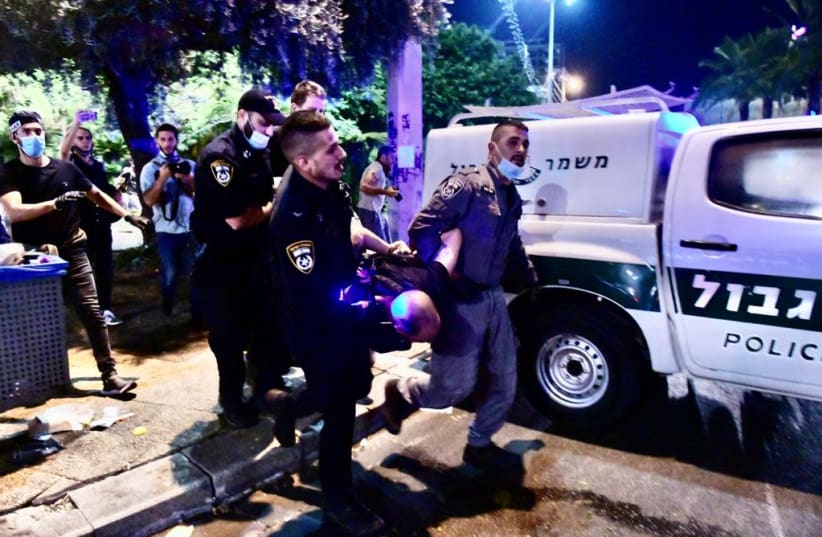 Police are seen arresting a protester at Tel Aviv's Rabin Square on June 6. (photo credit: AVSHALOM SASSONI/MAARIV)
