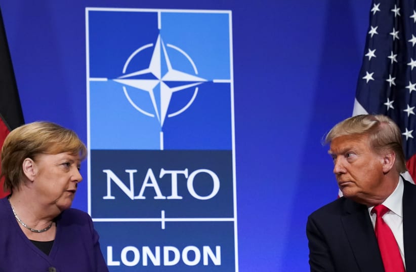 US President Donald Trump and Germany's Chancellor Angela Merkel hold a bilateral meeting at the sidelines of the NATO summit in Watford, Britain, December 4, 2019. (photo credit: KEVIN LAMARQUE/REUTERS)