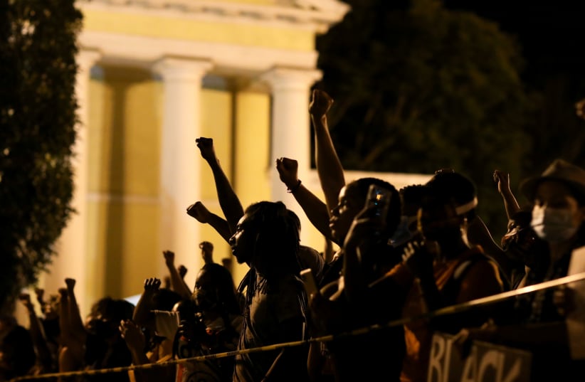 Demonstrators raise their fists in the air near the White House, during a protest against racial inequality in the aftermath of the death in Minneapolis police custody of George Floyd, in Washington, U.S., June 6, 2020 (photo credit: REUTERS/LEAH MILLIS)