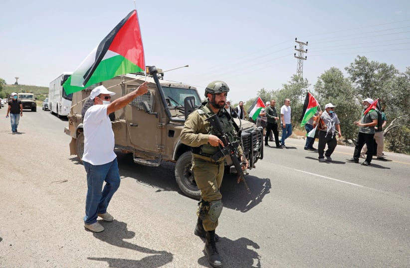 PALESTINIANS PROTEST the planned annexation. (photo credit: REUTERS)