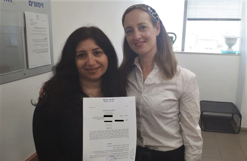 Vicky Tzur (left) is seen with attorney Tamar Oderberg holding the get. (photo credit: OHR TORAH STONE)