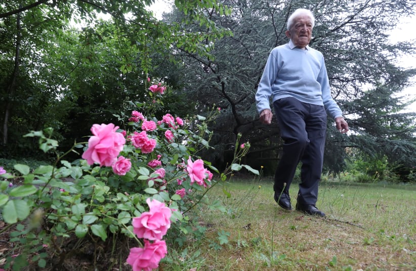 103-year-old Belgian oldest former general practitioner Alfons Leempoels walks in his garden intending to cover a distance equivalent of a marathon to raise money for scientists researching the coronavirus disease (COVID-19) in Rotselaar, Belgium June 9, 2020. (photo credit: YVES HERMAN/REUTERS)