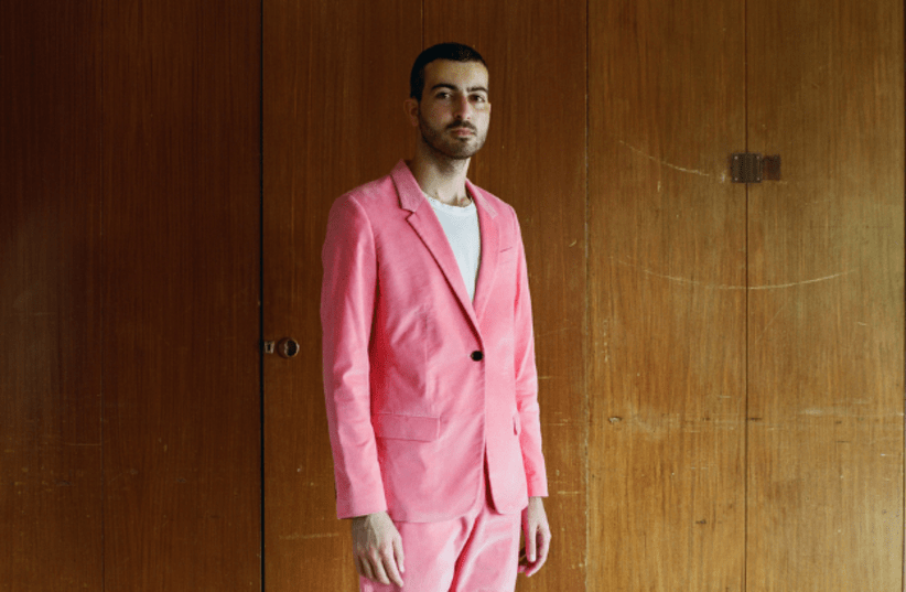 Ofir Lev, from Bezalel Academy’s Department of Jewelry and Fashion, wearing a pink women’s suit, in his home town, Kibbutz Sde Eliyahu (photo credit: MICHAEL TZUR/BEZALEL ACADEMY’S DEPARTMENT OF PHOTOGRAPHY/VIA VOGUE)