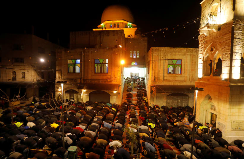 Palestinians perform the Fajr (Dawn) prayers outside Al-Nasir mosque in Nablus, in the West Bank February 14, 2020 (photo credit: REUTERS/RANEEN SAWAFTA)