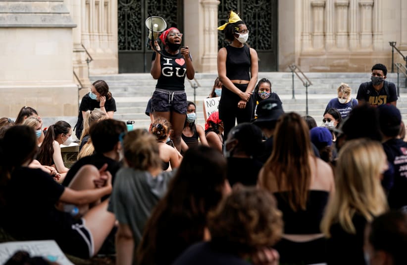 Demonstrators hold a Black Lives Matter sit-in to protest the death in Minneapolis police custody of George Floyd, outside the National Cathedral in Washington, D.C.,U.S., June 5, 2020 (photo credit: REUTERS/JOSHUA ROBERTS)