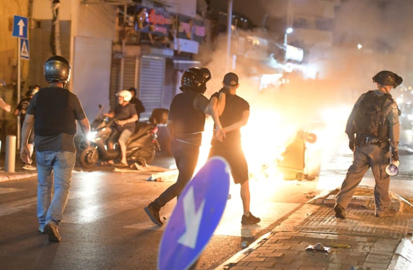 Israel Police officer arrests a protester at a demonstration in Jaffa, June 11, 2020.   (photo credit: ALON HACHMON)