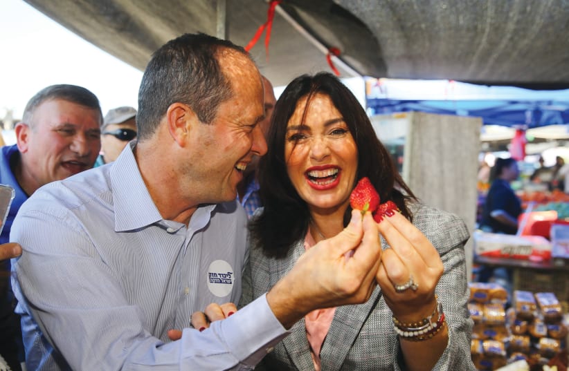 USING EACH other? Barkat and Miri Regev marvel over fruit as they tour an Ashdod market in April 2019. (photo credit: FLASH90)