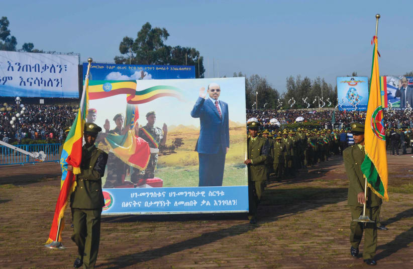 A PROCESSION escorts the flag-draped casket of Ethiopian prime minister Meles Zenawi during his funeral in the capital Addis Ababa in 2012. (photo credit: TIKSA NEGERI / REUTERS)