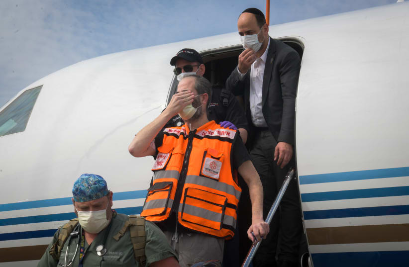 United Hatzalah founder and president Eli Beer closes his eyes to recite the ‘Shema’ as he arrives at Ben-Gurion International Airport on April 21 (photo credit: YEHUDA HAIM/FLASH90)