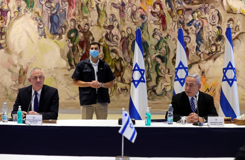 Prime Minister Benjamin Netanyahu and Defense Minister Benny Gantz attend a meeting of the new government at the Chagall Hall in the Knesset on May 24 (photo credit: ABIR SULTAN/POOL/VIA REUTERS)