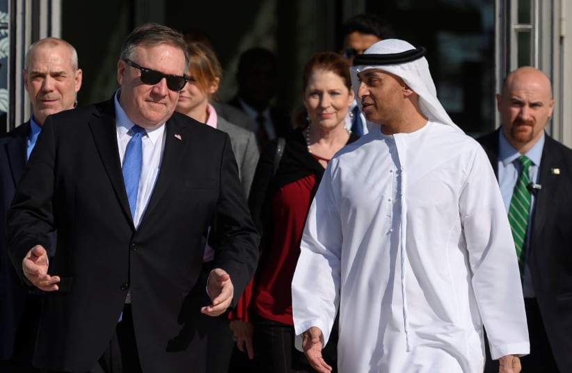 US Secretary of State Mike Pompeo speaks with the Emirati Ambassador to the US Yousef Al Otaiba at the NYU Abu Dhabi campus in Abu Dhabi, United Arab Emirates January 13, 2019 (photo credit: ANDREW CABALLERO-REYNOLDS/REUTERS)