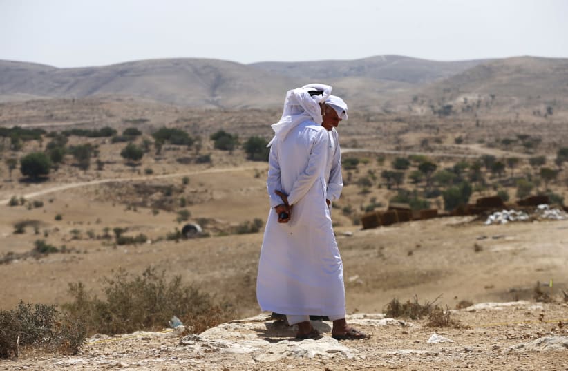 Bedouin men, residents of Umm Al-Hiran, a Bedouin village which is not recognised by the Israeli government, speak during a protest against the building of a Jewish community on the land of Umm Al-Hiran, in Israel's southern Negev desert August 27, 2015 (photo credit: REUTERS/AMMAR AWAD)