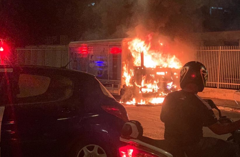 A water truck in flames after an uneasy night in Jaffa  (photo credit: ALON HACHMON)