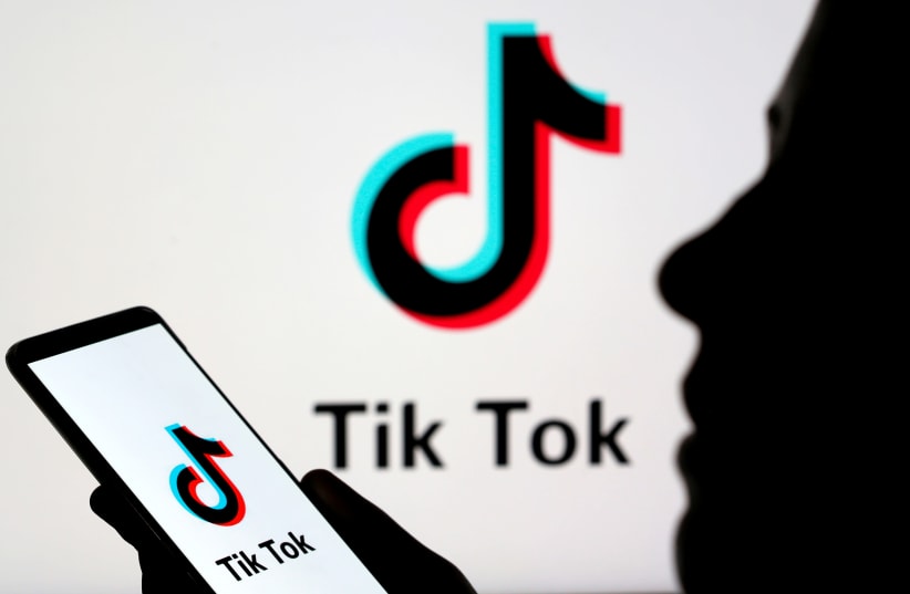 A person holds a smartphone with Tik Tok logo displayed in this picture illustration taken November 7, 2019. (photo credit: REUTERS/DADO RUVIC/ILLUSTRATION/FILE PHOTO)