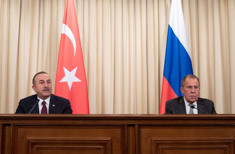 Turkish Foreign Minister Mevlut Cavusoglu and Russian Foreign Minister Sergei Lavrov attend a joint news conference following their talks in Moscow, Russia January 13, 2020 (photo credit: PAVEL GOLOVKIN/POOL VIA REUTERS)