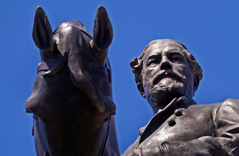 Activists in Richmond, Virginia, took a different approach to vandalizing Cofederate statues by projecting the image of a Pride flag and the initials for Black Lives Matter on a statue of Confederate General Robert E. Lee Friday night in support of black LGBT rights, CNN reported.  Ever since the st (photo credit: JAY PAUL/REUTERS)