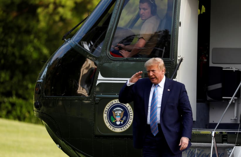 U.S. President Donald Trump salutes from the steps of Marine One helicopter on the South Lawn of the White House upon his return to Washington, U.S. (photo credit: REUTERS/YURI GRIPAS)