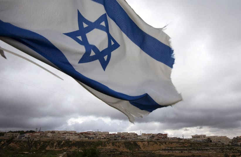Israeli flag is seen. (photo credit: RONEN ZVULUN/REUTERS)