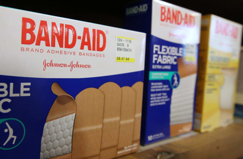 Johnson & Johnson band-aids sit on a shelf at the Rock Canyon Pharmacy, in Provo, Utah on May 9, 2019. (photo credit: GEORGE FREY/ REUTERS)