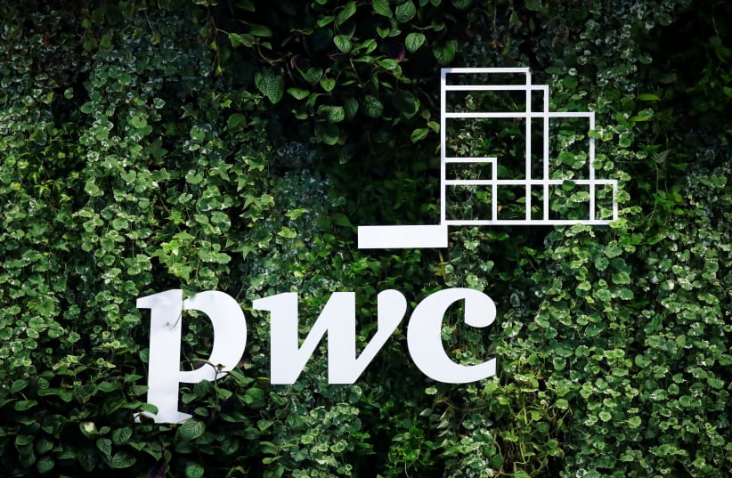 The logo of accounting firm PricewaterhouseCoopers (PwC) is seen on a board at the St. Petersburg International Economic Forum (SPIEF), Russia (photo credit: REUTERS/MAXIM SHEMETOV)