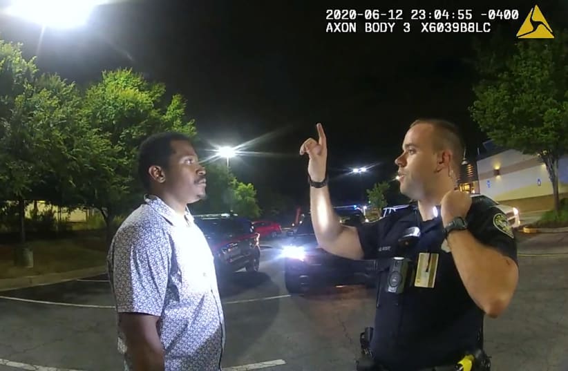 Former Atlanta Police Department officer Garrett Rolfe conducts a field sobriety test on 27-year-old Rayshard Brooks in a Wendy's restaurant parking lot in a still image from the video body camera of officer Devin Bronsan in Atlanta, Georgia, U.S. June 12, 2020. Video taken June 12, 2020 (photo credit: ATLANTA POLICE DEPARTMENT/HANDOUT VIA REUTERS)