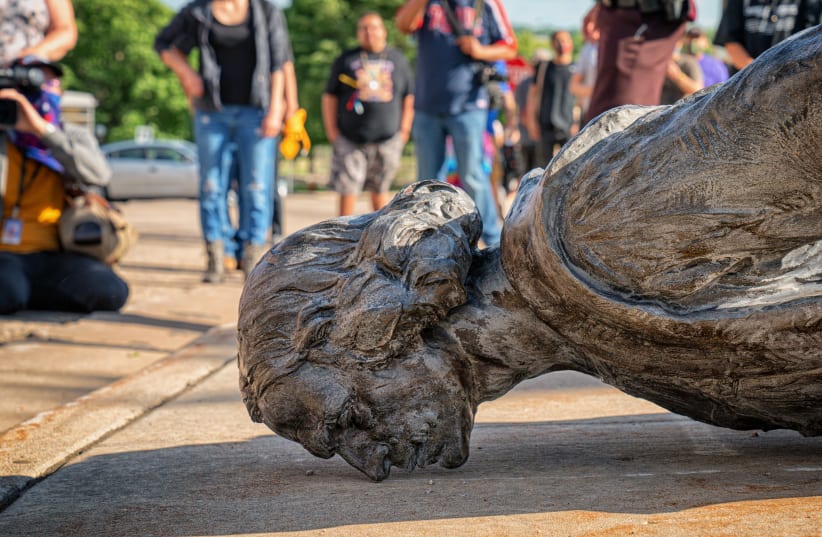 A CHRISTOPHER COLUMBUS statue lies on the ground outside the Minnesota State Capitol, after taking a forced nosedive on June 10. (photo credit: TONY WEBSTER/FLICKR)