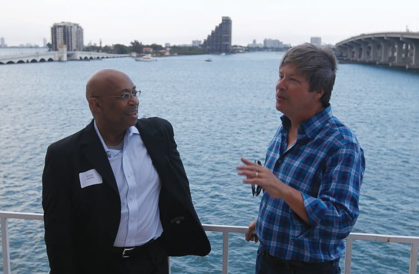 PULITZER PRIZE-WINNING photojournalist Michel duCille (left) with Pulitzer Prize-winning humorist and syndicated ‘Miami Herald’ columnist Dave Barry in Miami in 2013 for the newspaper’s relocation party. (photo credit: ANDREW INNERARITY / REUTERS)
