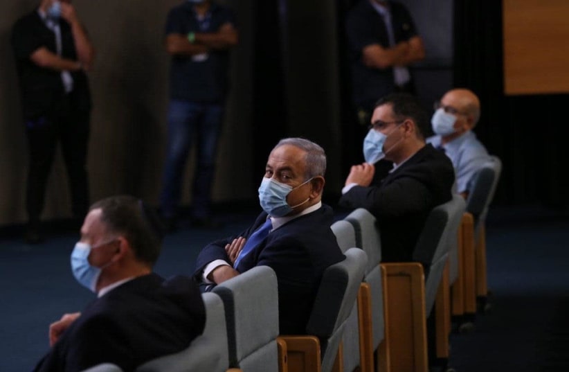Prime Minister Benjamin Netanyahu at the ceremony marking the retirement of Health Ministry director-general Moshe Bar Siman Tov on June 18, 2020 (photo credit: Courtesy)