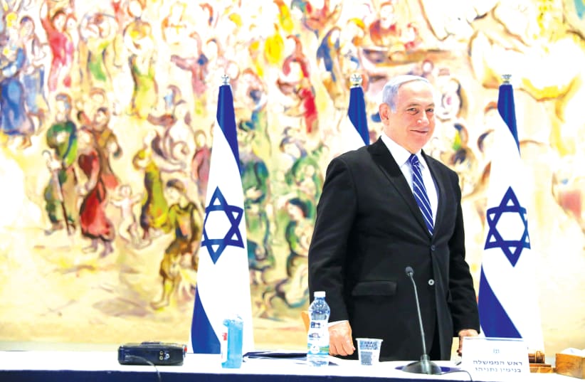 PRIME MINISTER Benjamin Netanyahu attends a cabinet meeting at the Chagall Hall in the Knesset in May. (photo credit: ABIR SULTAN / REUTERS)