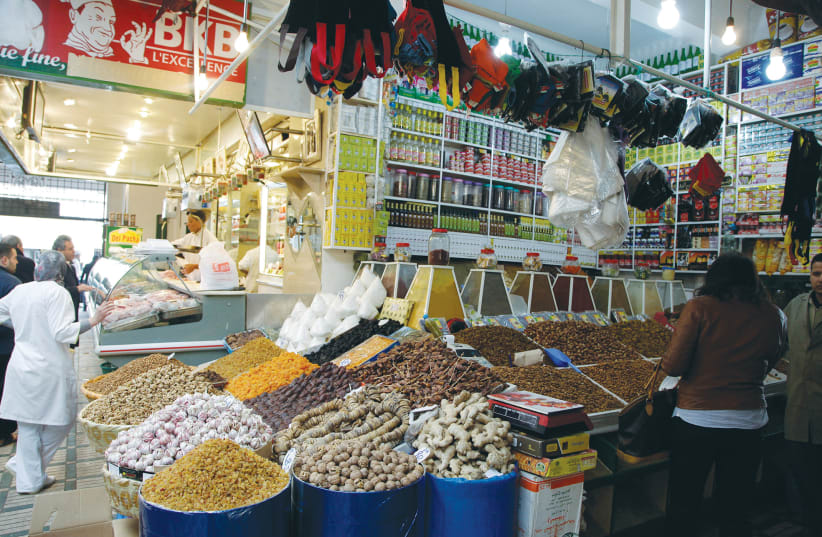 VENDORS SERVE customers at a market in Rabat in 2013. (photo credit: REUTERS)