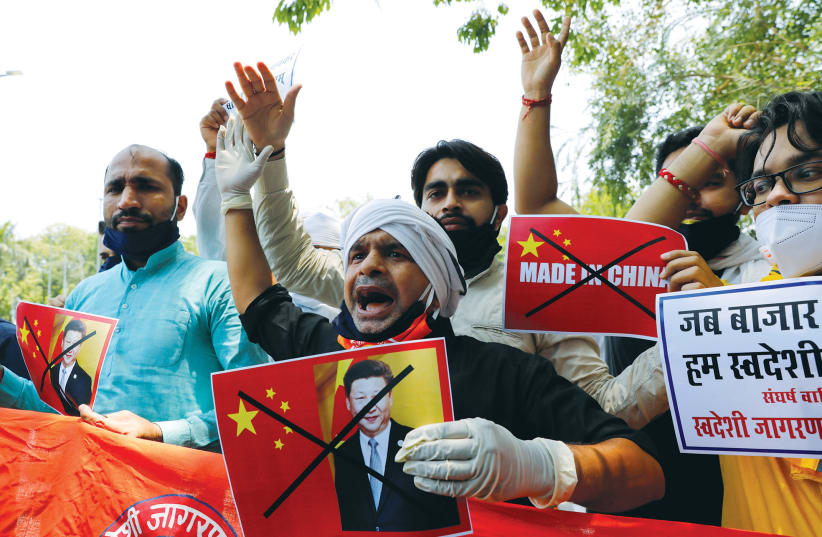 ACTIVISTS SHOUT slogans during a protest against China, in New Delhi on Wednesday. (photo credit: REUTERS/ANUSHREE FADNAVIS)