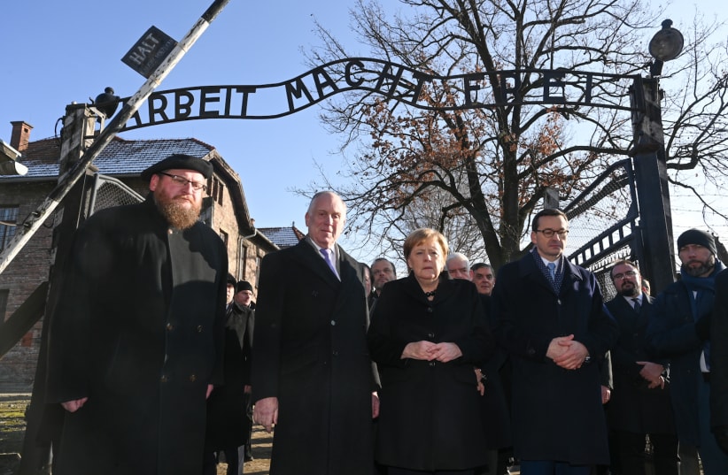 On December 6, 2019, in front of the notorious gate at the site of the former Auschwitz- Birkenau concentration and extermination camp marked “Arbeit Macht Frei” (Work Sets You Free), from  left to right: Piotr M.A. Cywinski, Director of the Auschwitz-Birkenau State Museum and President of the Ausch (photo credit: SHAHAR AZRAN / WJC)