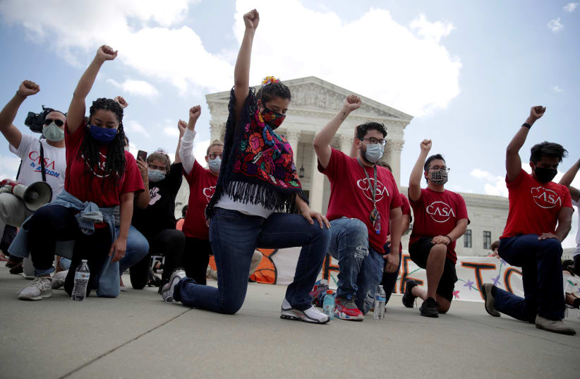 People take a knee in support of the Black Lives Matter movement outside the US Supreme Court in Washington, US, June 18, 2020 (photo credit: JONATHAN ERNST / REUTERS)