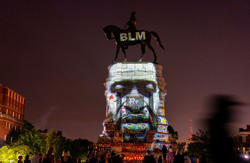 An image of George Floyd is projected on the statue of Confederate General Robert E. Lee in Richmond, Virginia, U.S. June 20, 2020 (photo credit: REUTERS)