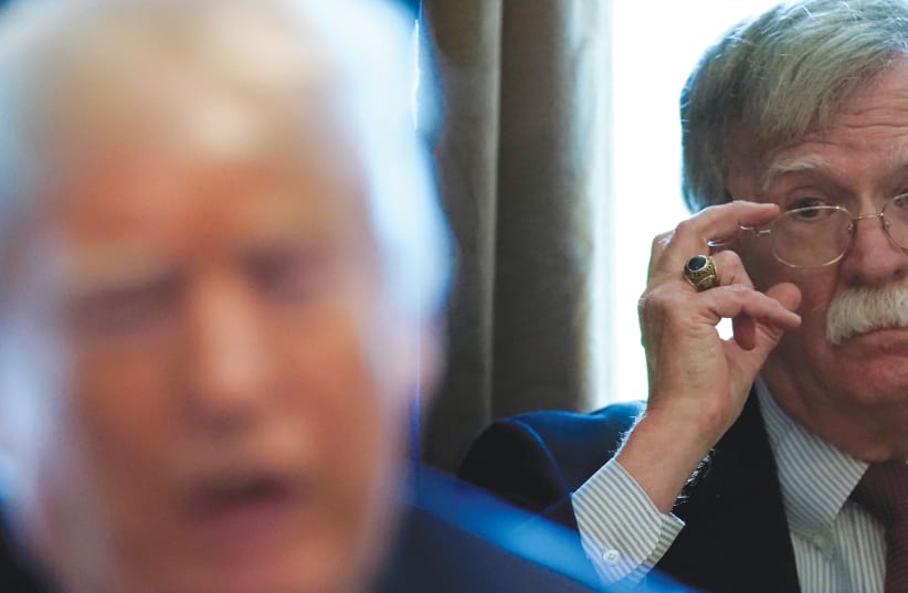 FORMER NATIONAL security advisor John Bolton listens to US President Donald Trump at the White House in 2018. (photo credit: REUTERS/KEVIN LAMARQUE/FILE PHOTO)