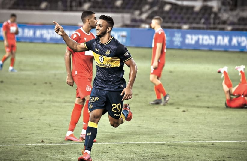 MACCABI TEL AVIV forward Eylon Almog celebrates after scoring the yellow-and-blue’s second goal during stoppage time of the club’s 2-0 derby victory over Hapoel Tel Aviv at Bloomfield Stadium in Premier League Championship Playoff action. (photo credit: ARIEL SHALOM)