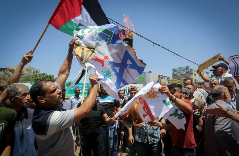 The Palestinians participate in a march rejecting the policy of the Israeli annexation project in the West Bank and the Jordan Valley and the deal of the century, in Rafah in the southern Gaza Strip, on June 11, 2020. (photo credit: ABED RAHIM KHATIB/FLASH90)