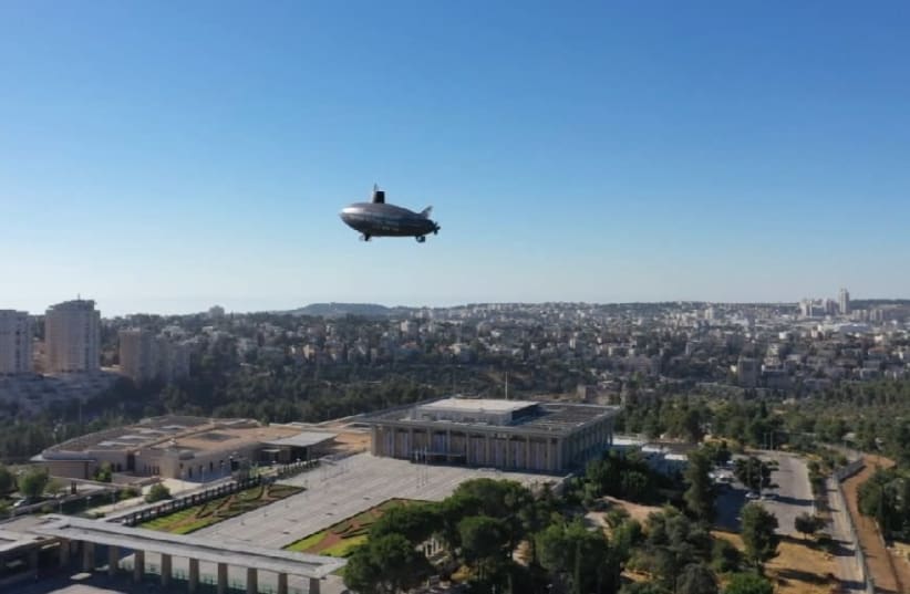 A Zeppelin in seen above the Knesset, protesting Prime Minister Benjamin Netanyahu's submarine affair (photo credit: NOAM MOSKOWITZ)