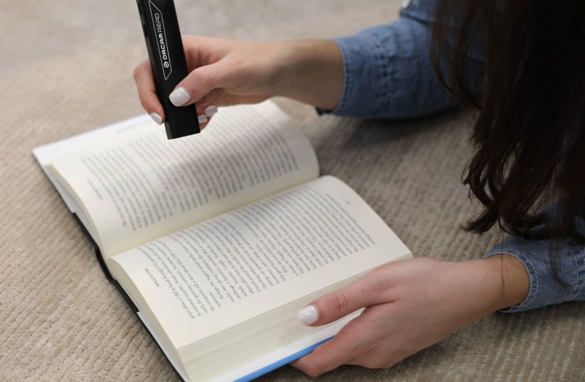 OrCam Read is a lightweight, handheld device with a smart camera that seamlessly reads text from any printed surface or digital screen (photo credit: Courtesy)