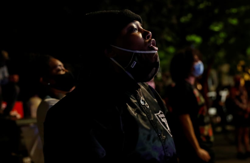 People wearing protective face masks take part in a protest following the death of African-American George Floyd. Brooklyn, New York City, May 29, 2020 (photo credit: SHANNON STAPLETON / REUTERS)
