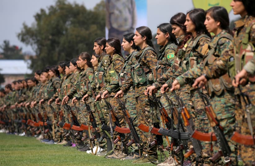 KURDISH FEMALE fighters of the Women’s Protection Unit (YPJ) take part in a military parade as they celebrate victory over Islamic State, in Qamishli, Syria, in March 2019. (photo credit: REUTERS/RODI SAID)
