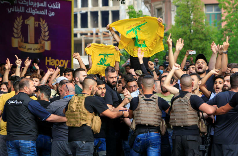 Lebanese army try to block supporters of the Lebanese Shi'ite groups Hezbollah and Amal as they gesture and chant slogans against anti-government demonstrators, in Beirut (photo credit: REUTERS)
