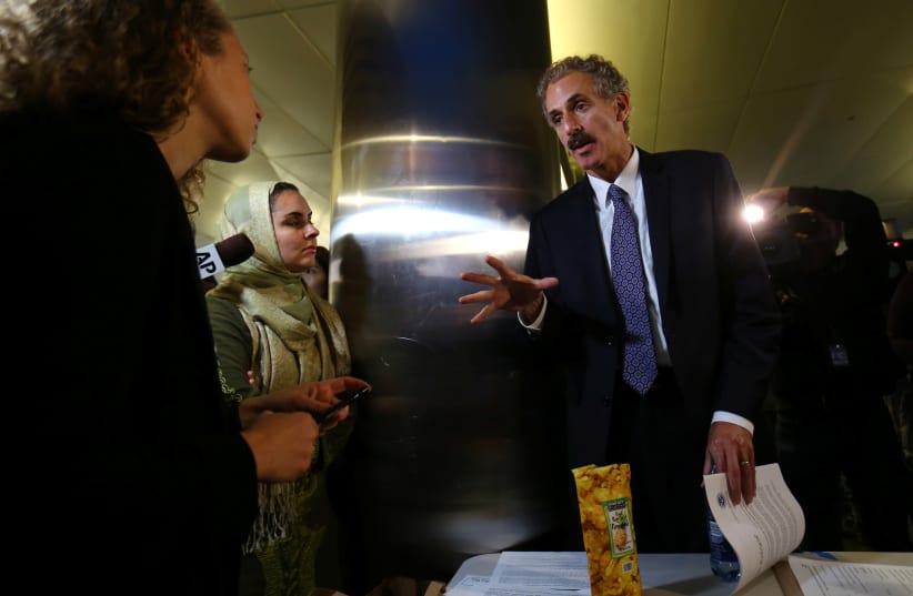 Los Angeles City Attorney Mike Feuer speaks with volunteer lawyers set up outside the arrivals area after the reinstatement by the U.S. Supreme Court of portions of President Donald Trump's executive order targeting travelers from six predominantly Muslim countries, in Los Angeles, California, U.S., (photo credit: MIKE BLAKE/REUTERS)