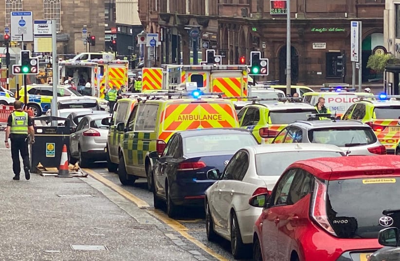 Emergency respoders are seen near a scene of reported stabbings, in Glasgow, Scotland, Britain June 26, 2020 (photo credit: @JATV_SCOTLAND/VIA REUTERS)