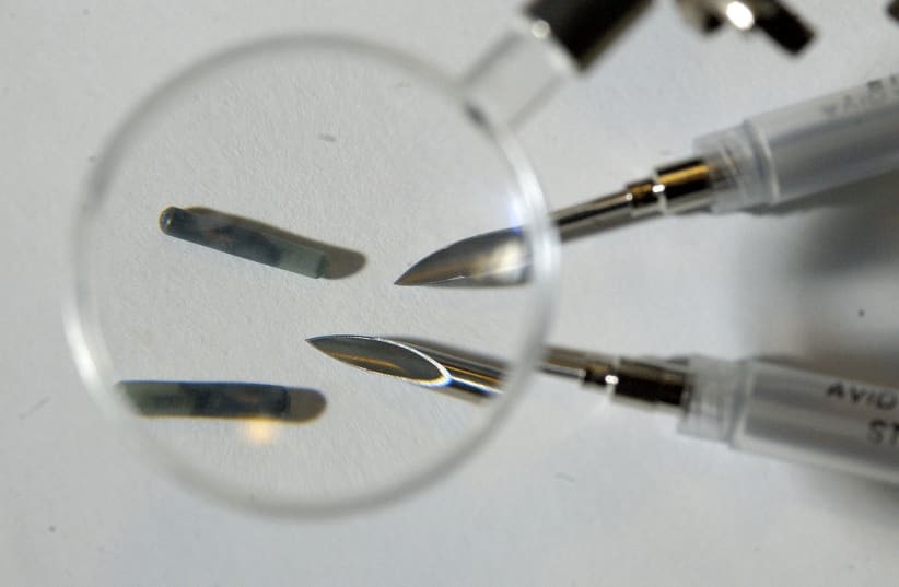 Radio Frequency Identification microchips with the needles used to implant them in New York (photo credit: REUTERS)
