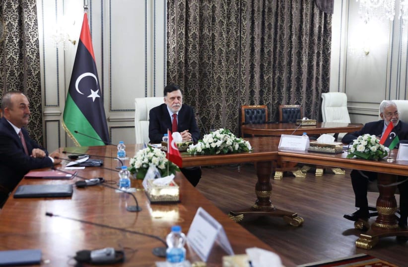 Libya's internationally recognised Prime Minister Fayez al-Serraj meets with Turkish Foreign Minister Mevlut Cavusoglu and Senior Turkish officials in Tripoli, Libya June 17, 2020. (photo credit: REUTERS)