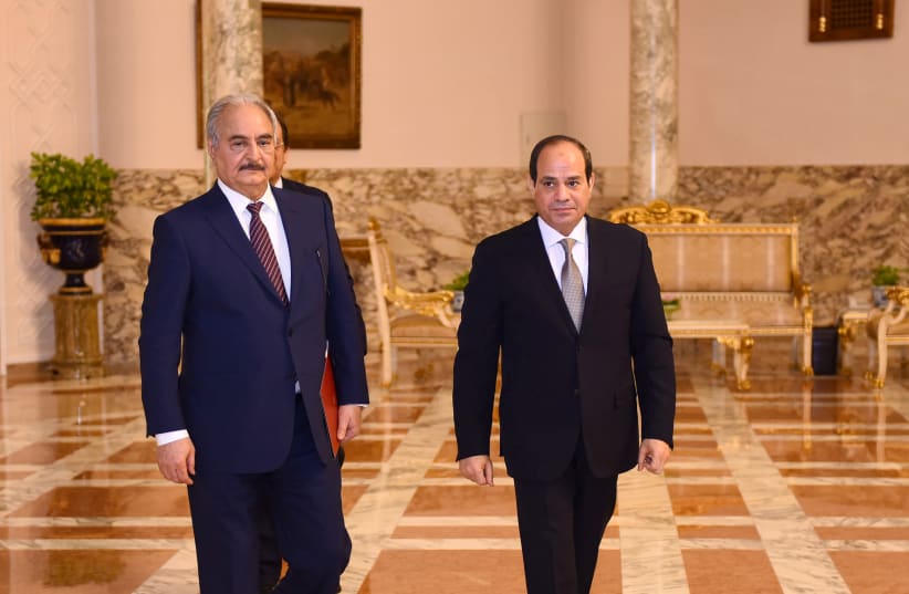 LIBYAN MILITARY commander Khalifa Haftar (left) walks with Egyptian President Abdel Fattah al-Sisi at the Presidential Palace in Cairo in April 2019. (photo credit: REUTERS)