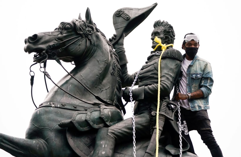 A protestor wraps chains and ropes around the statue of U.S. President Andrew Jackson, June 22, 2020 (photo credit: JOSHUA ROBERTS / REUTERS)